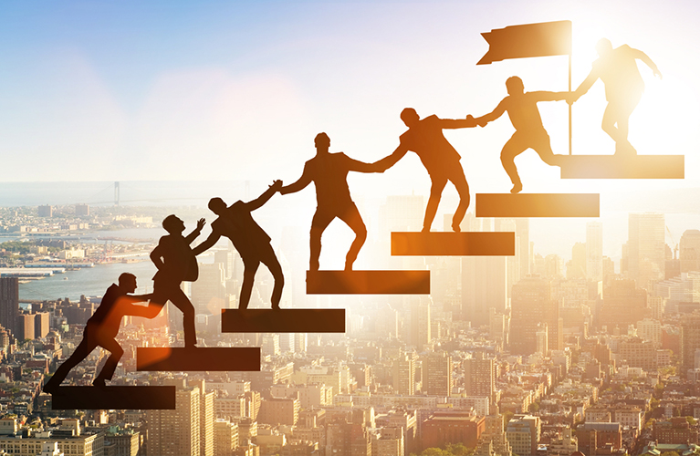 business people climbing steps holding hands