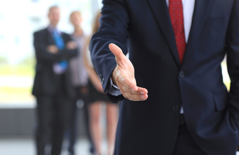 man-in-suit-offering-handshake